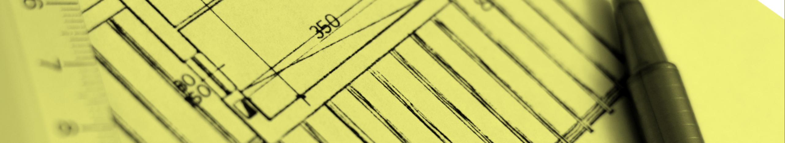 Cropped, close up image of sketched floor plan, with a ruler on the left side and a black pen on the right side.