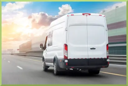image of the back of a white delivery van traveling down a highway